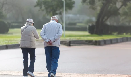 49795074 couple walking on the promenade on a sunny day