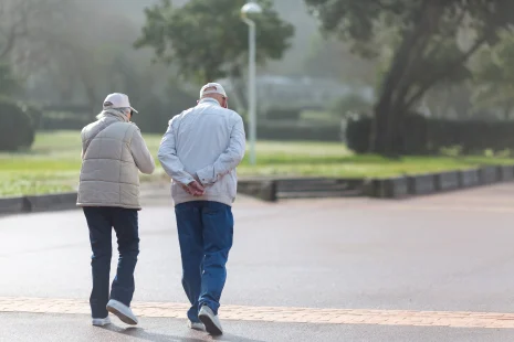 49795074 couple walking on the promenade on a sunny day