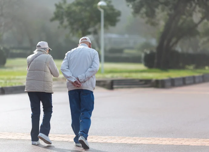 49795074 couple walking on the promenade on a sunny day