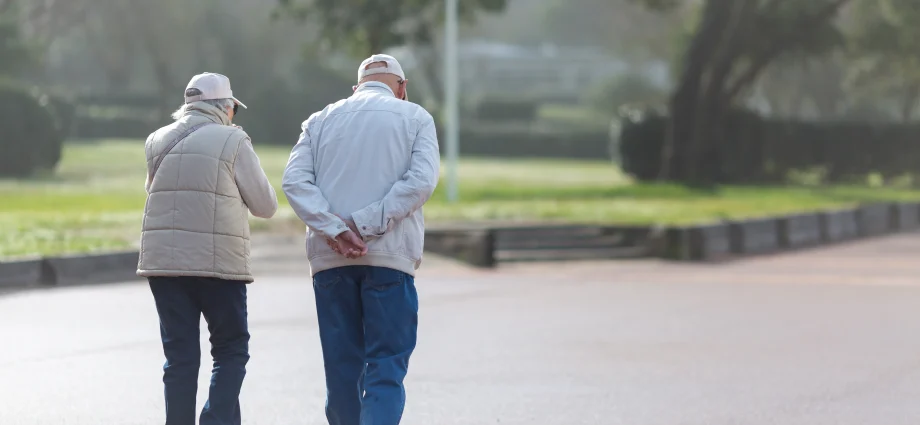 49795074 couple walking on the promenade on a sunny day